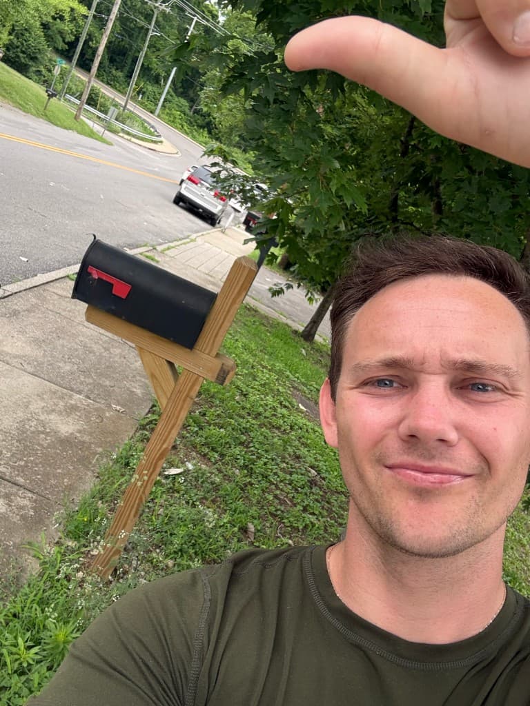Mailbox Bros team member at a finished black post-mount mailbox install in Sacramento